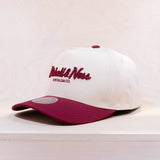 White and maroon cap with Mitchell & Ness logo on a light background