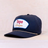 Navy blue cap with Topo Designs logo on a light beige background
