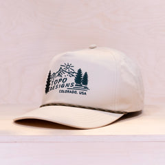 White cap with Topo Designs logo on a light gray background